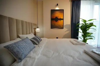 a bedroom with a large white bed with blue pillows at Dream house 22 in Istanbul