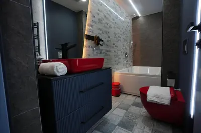 a bathroom with a red toilet and a bath tub at Dream house 22 in Istanbul
