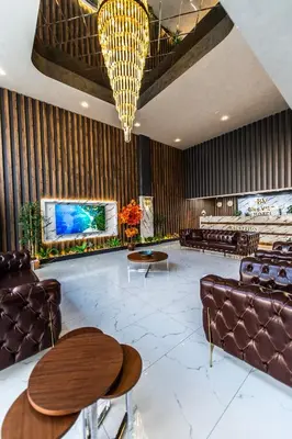 a lobby with couches and tables and a chandelier at Blue Vista Houses & Spa in Esenyurt