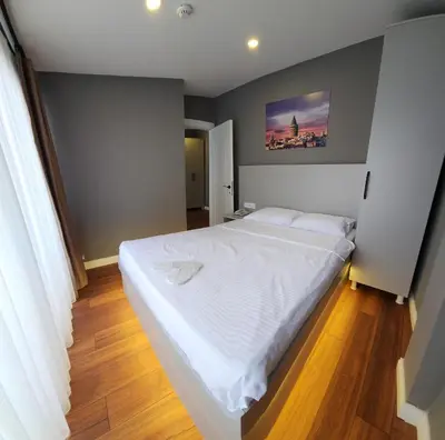 a bedroom with a large white bed in a room at TAKSİM GOKOTTA SUiTE in Istanbul