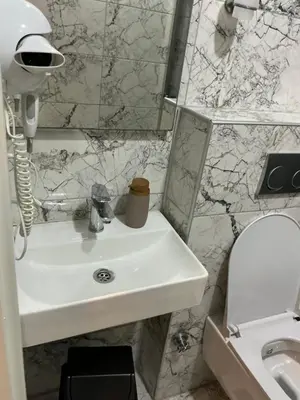 a bathroom with a sink and a toilet at TAKSİM GOKOTTA SUiTE in Istanbul