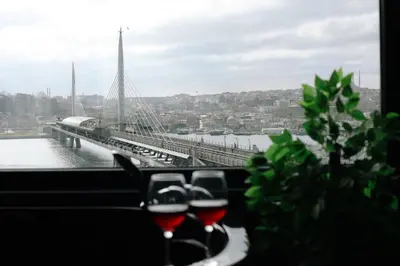 a view of a bridge with glasses of wine at Karaköy in Karaköy Hotel in Istanbul
