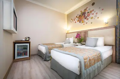 a hotel room with two beds and a tv at Fatih Hotel Corner in Istanbul