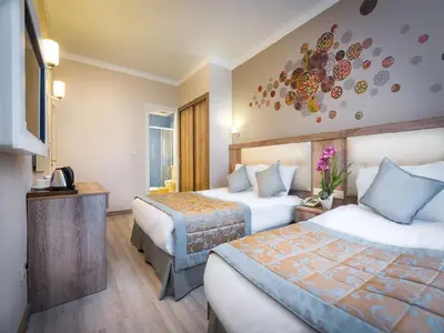 a hotel room with two beds and a television at Fatih Hotel Corner in Istanbul