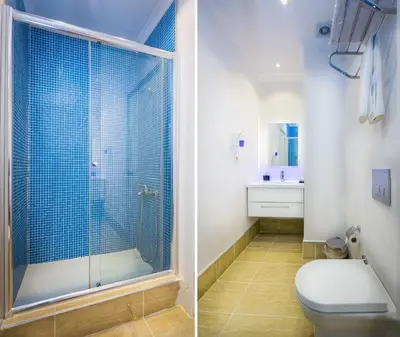a bathroom with a toilet and a glass shower at Fatih Hotel Corner in Istanbul