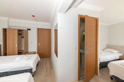 a small room with two beds and a closet at Metro Hotel in Istanbul