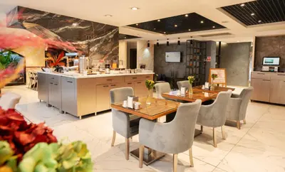 a restaurant with two tables and chairs and a kitchen at Orya Hotel in Istanbul