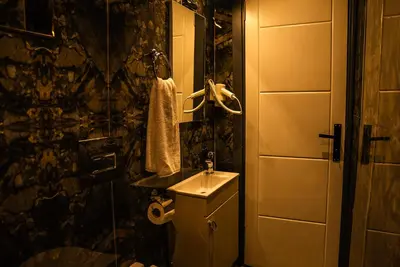 a small bathroom with a sink and a shower at CK PALACE Hotel in Istanbul