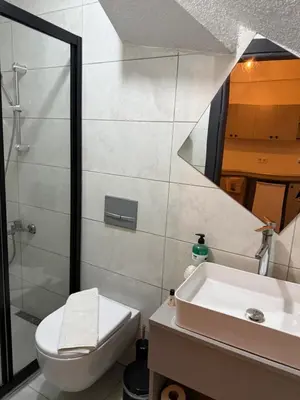 a bathroom with a sink and a toilet and a mirror at Taksim Nova homes in Istanbul