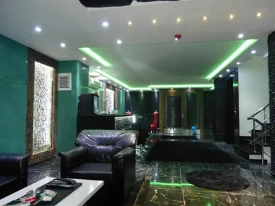 a living room with green walls and a couch at Ag Şişli Hotel in Istanbul