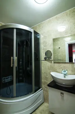 a bathroom with a glass shower and a sink at Ag Şişli Hotel in Istanbul