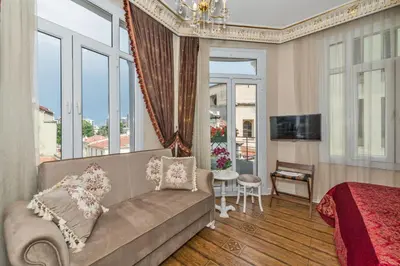a bedroom with a couch and a bed and a window at IQ Hotel in Istanbul