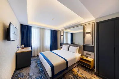 a hotel room with a bed and a television at AHG Atlas Hotel Taksim in Istanbul
