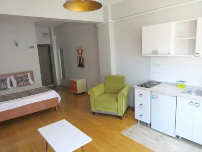 a small room with a bed and a green chair at Istanberry - Vanilla Apartments in Istanbul