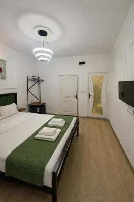 a bedroom with a large bed with towels on it at 24 BOUTİQUE HOTEL in Istanbul