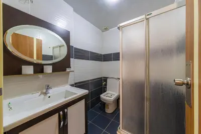 a bathroom with a sink and a toilet and a mirror at İSTA PALACE-GRAND BAZAAR in Istanbul