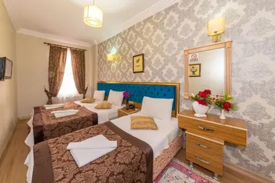 a hotel room with two beds and a mirror at İSTA PALACE-GRAND BAZAAR in Istanbul