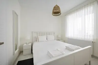 a white bedroom with a large white bed and a window at Private Modern 2BR1Bath Bebek Gem! #80 in Istanbul