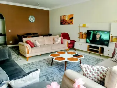 a living room with a couch and a tv at Orbital Travel House 1 in Istanbul