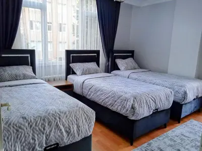 a bedroom with two beds and a window at Orbital Travel House 1 in Istanbul