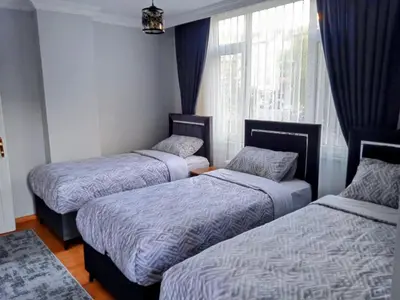 three beds in a room with a window at Orbital Travel House 1 in Istanbul
