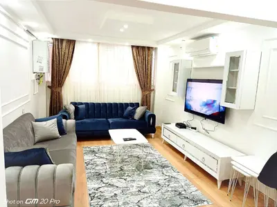 a living room with a couch and a tv at Orbital Travel House 1 in Istanbul