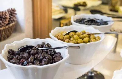 three bowls of olives and spoons on a shelf at MidMar Deluxe Hotel in Istanbul