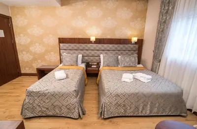 a hotel room with two beds and a table at MidMar Deluxe Hotel in Istanbul