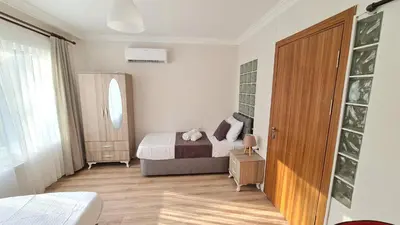 a bedroom with a bed and a wooden door at Cozy Spacious near Green Mosque in Yıldırım