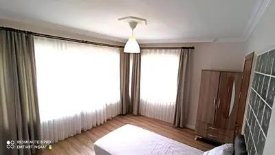 a bedroom with a bed and a large window at Cozy Spacious near Green Mosque in Yıldırım