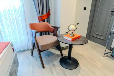 a room with a table and a chair and a small table with a globe at Atar Airport Hotel - Restaurant & Spa Wellness in Arnavutköy