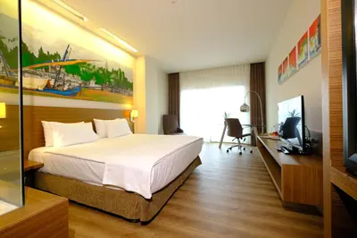 a bedroom with a bed and a desk and a television at Gorrion Hotel Istanbul in Istanbul