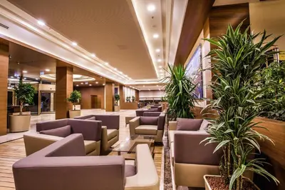 a waiting room with chairs and plants at Gorrion Hotel Istanbul in Istanbul