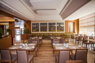 a dining room with wooden tables and chairs at Gorrion Hotel Istanbul in Istanbul