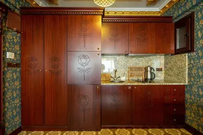 a kitchen with wooden cabinets in a room at The First Ottoman Apartments in Istanbul