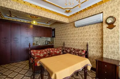 a dining room with a table and a couch at The First Ottoman Apartments in Istanbul