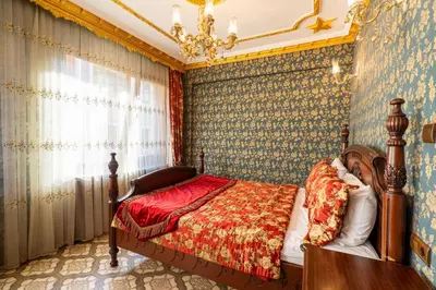 a bedroom with a bed and a chandelier at The First Ottoman Apartments in Istanbul