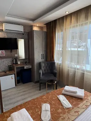 a hotel room with a bed and a chair at Peker Hotel in Istanbul