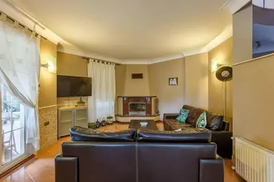 a living room with a leather couch and a tv at Villa Moon in Gebze