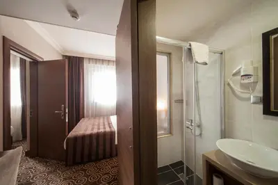 a bathroom with a sink and a toilet and a sink at Delta Hotel Istanbul & Old City in Istanbul