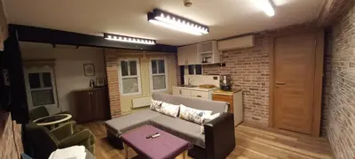 a living room with a couch and a kitchen at Coskun House in Istanbul