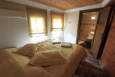 a bedroom with a bed and a bathroom with a toilet at Coskun House in Istanbul