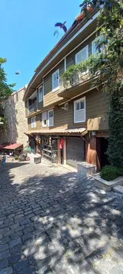 a building with a bird flying over a cobblestone street at Coskun House in Istanbul
