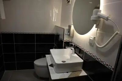 a bathroom with a sink and a toilet and a mirror at Galata istanbul Hotel in Istanbul