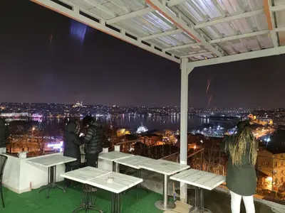 a group of people standing on top of a building at night at Galata istanbul Hotel in Istanbul
