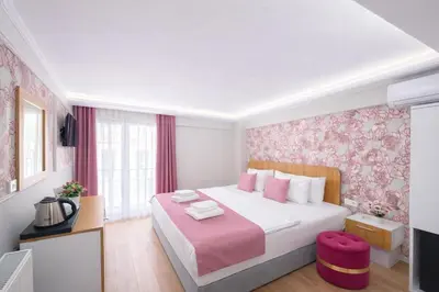 a bedroom with a large bed with pink floral wallpaper at Ria Suites Boutique Hotel in Istanbul