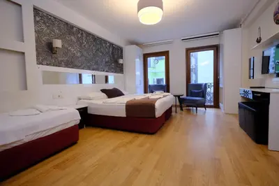 a hotel room with two beds and a desk at ottogreensuit in Istanbul