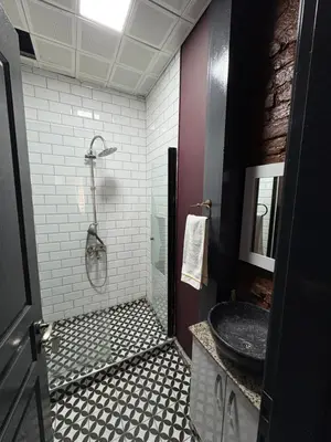 a bathroom with a shower and a sink and a tub at ottogreensuit in Istanbul
