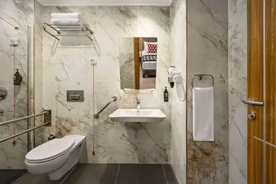 a bathroom with a toilet and a sink at Ramada Encore by Wyndham Istanbul Sisli in Istanbul
