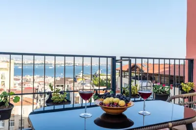 a table with two glasses of wine and a bowl of fruit at Atlas Han Hotel in Istanbul